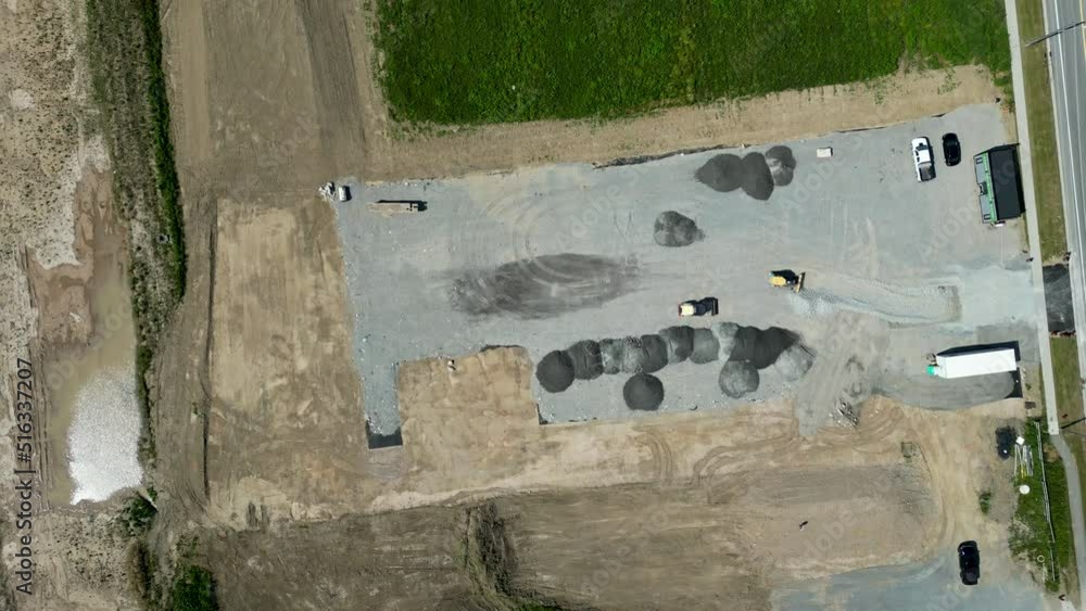 Top down aerial over construction zone area laying out gravel foundation Top down aerial over construction zone area laying out gravel foundation
