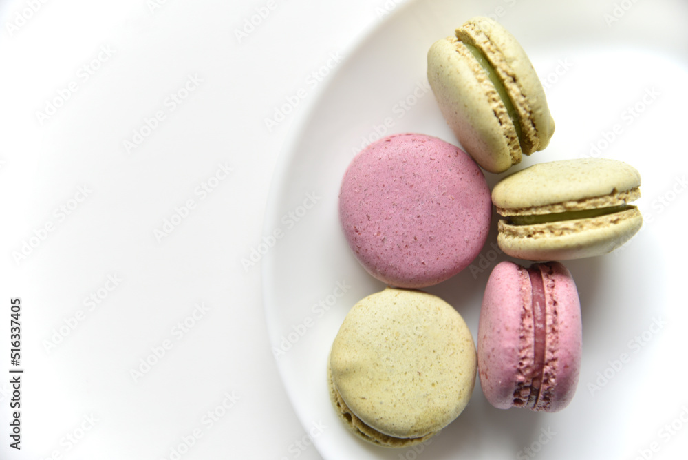 Macaroons. Sweet French desserts. Macaroons on a white plate. Macaroons on the table in the afternoon. Macaroons. Sweet French desserts. Macaroons on a white plate. Macaroons on the table in the afternoon.