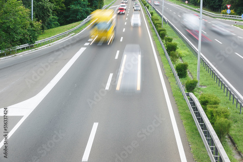Fast blurred motion drive on the highway. High angle view of traffic on highway in sunset. Transportation and travel concept