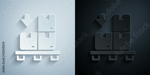 Paper cut Cardboard boxes on pallet icon isolated on grey and black background. Closed carton delivery packaging box with fragile signs. Paper art style. Vector