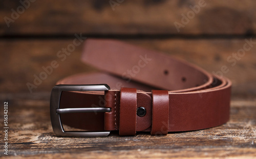 Men's belt for pants on an aged vintage wooden background