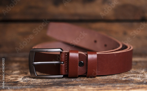 Men's belt for pants on an aged vintage wooden background