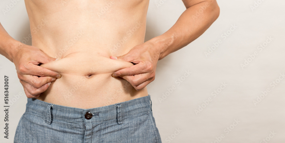 Naklejka premium お腹の脂肪に気になるダイエットする男性の姿