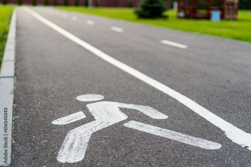 Obraz premium bicycle path, bicycle and running track, pedestrian sign on asphalt
