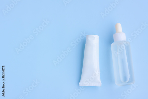 Cosmetic bottles on blue background