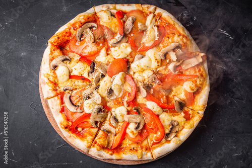 hot delicious traditional italian pizza on a dark stone background