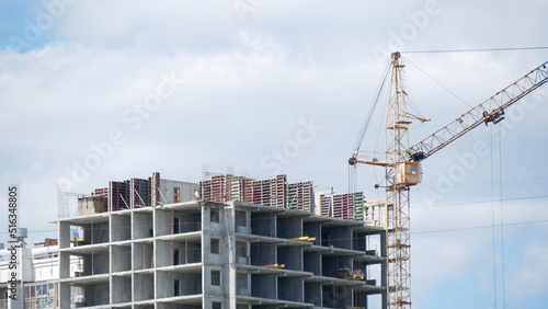 Building house with a construction crane. Construction of a multi-storey building.