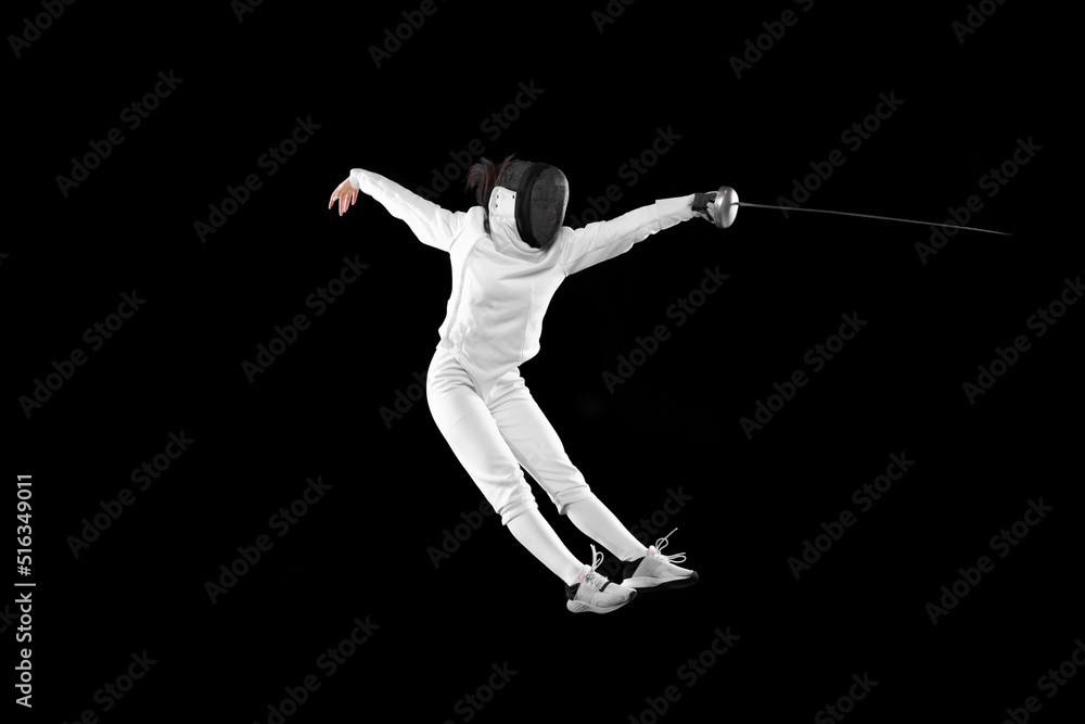 Energetic female fencer in white fencing costume and mask in action, motion isolated on dark background. Sport, youth, activity, skills, achievements, goal. Energetic female fencer in white fencing costume and mask in action, motion isolated on dark background. Sport, youth, activity, skills, achievements, goal.