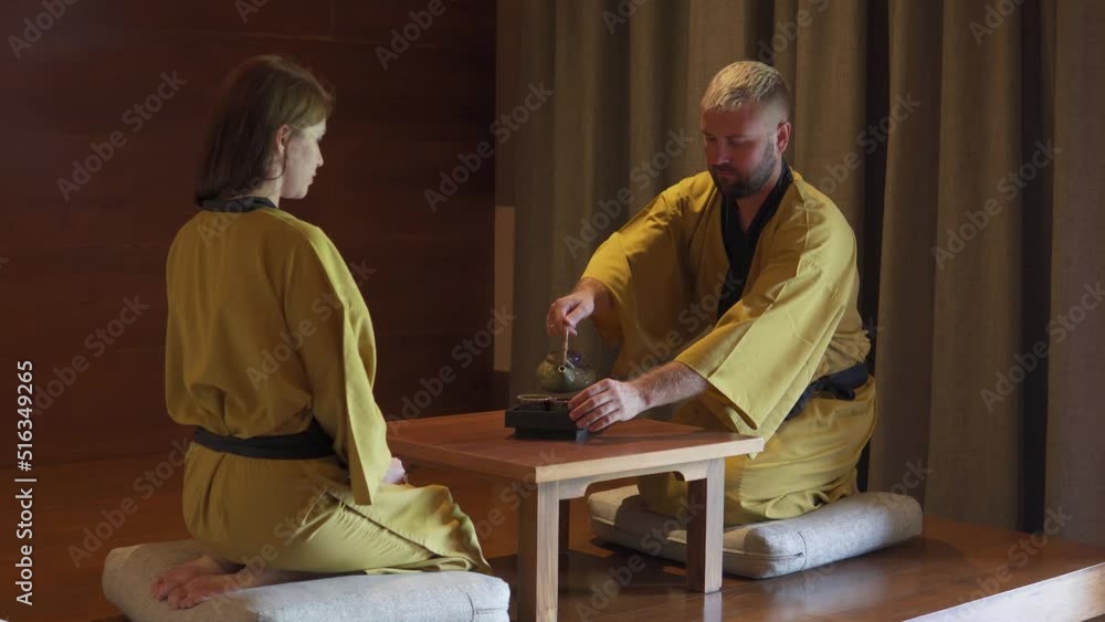 A couple greeting each other with folded hand before having lunch. Japanese style hotel A couple greeting each other with folded hand before having lunch. Japanese style hotel