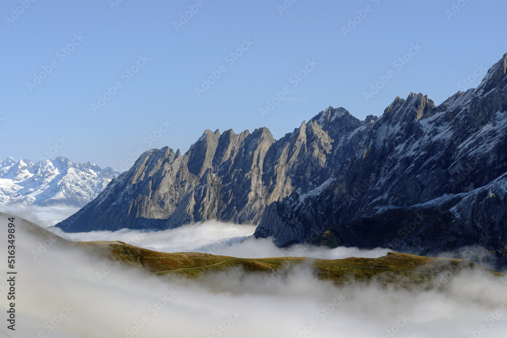Mountains and clouds in the valley. Natural landscape high in the mountains. Grindewald, Switzerland.