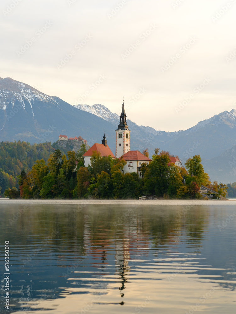 Iconic view of the Lake Bled in Slovenia. Church on an island in the middle of the lake. Summer landscape at dawn.