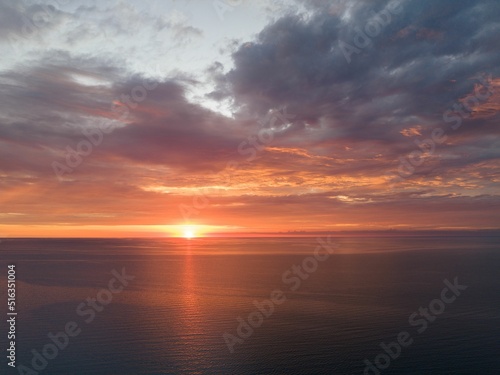 Aerial view of the tranquil Sodus Bay, New York reflecting a beautiful sunset under a cloudy sky photo