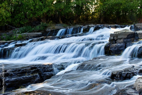 Beautiful long exposure Fraser waterfall in La Malbaie, Quebec, Canada photo