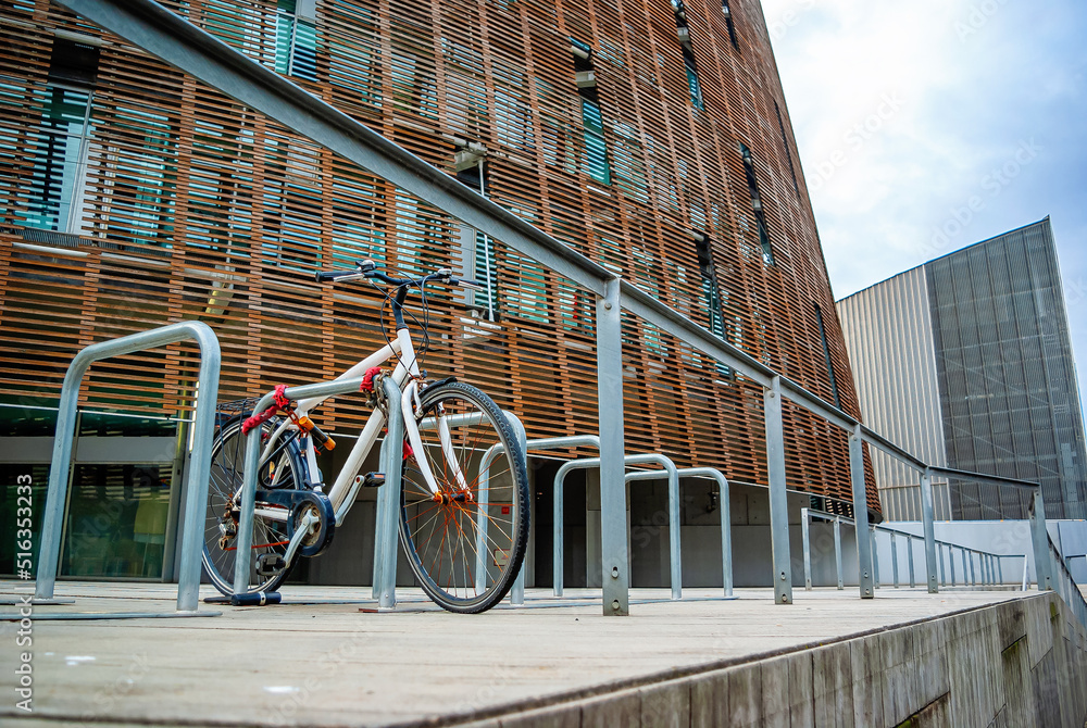 Parked bicycle near a business center in the city Parked bicycle near a business center in the city