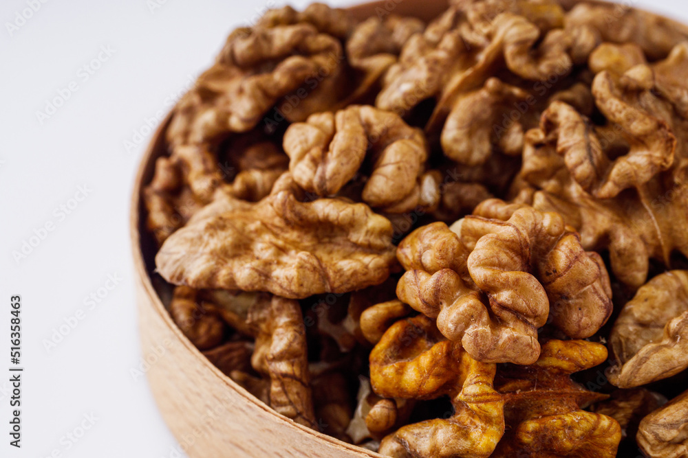 dried walnuts on a white acrylic background dried walnuts on a white acrylic background