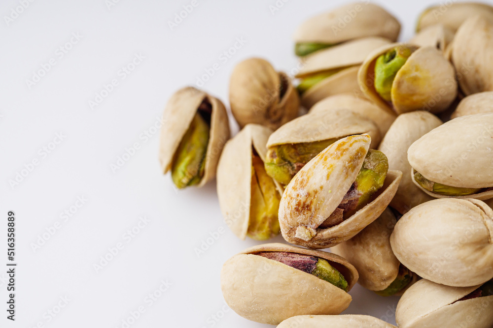 fresh salted pistachios on a white background fresh salted pistachios on a white background