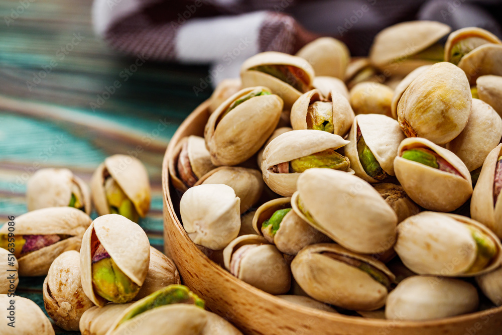 fresh salted pistachios on a wooden rustic background fresh salted pistachios on a wooden rustic background