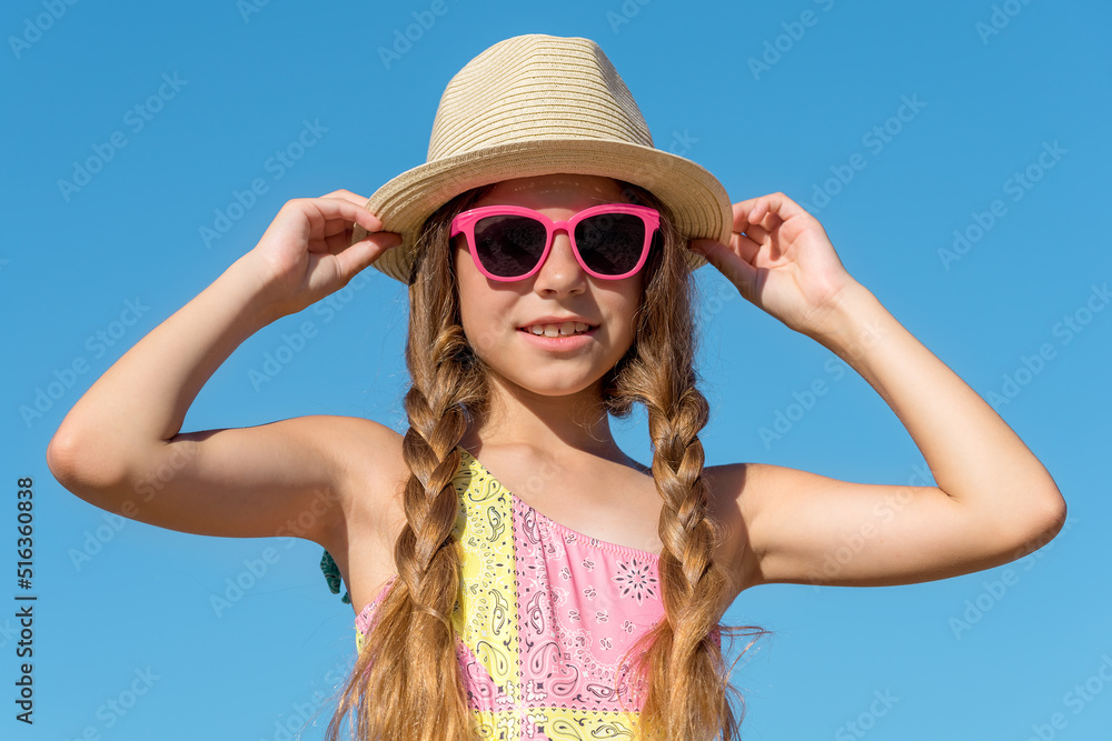 Close-up of a smiling young girl in a summer hat Close-up of a smiling young girl in a summer hat