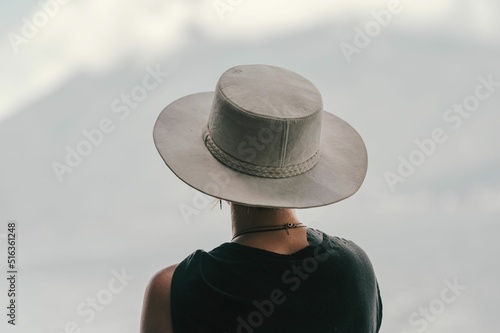 Back view of a stylish female in a boater hat by the Lake Atitlan, Guatemala