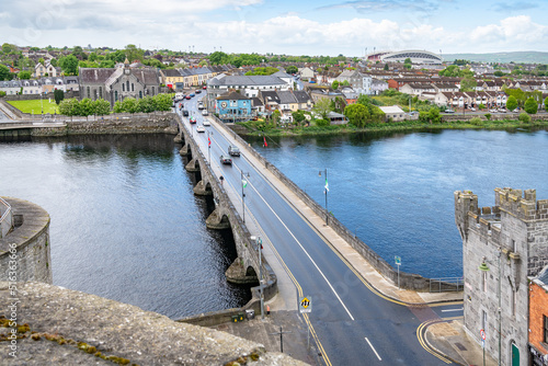Thomond Bridge across the River Shannon from King John's Castle, Limerick, Ireland photo