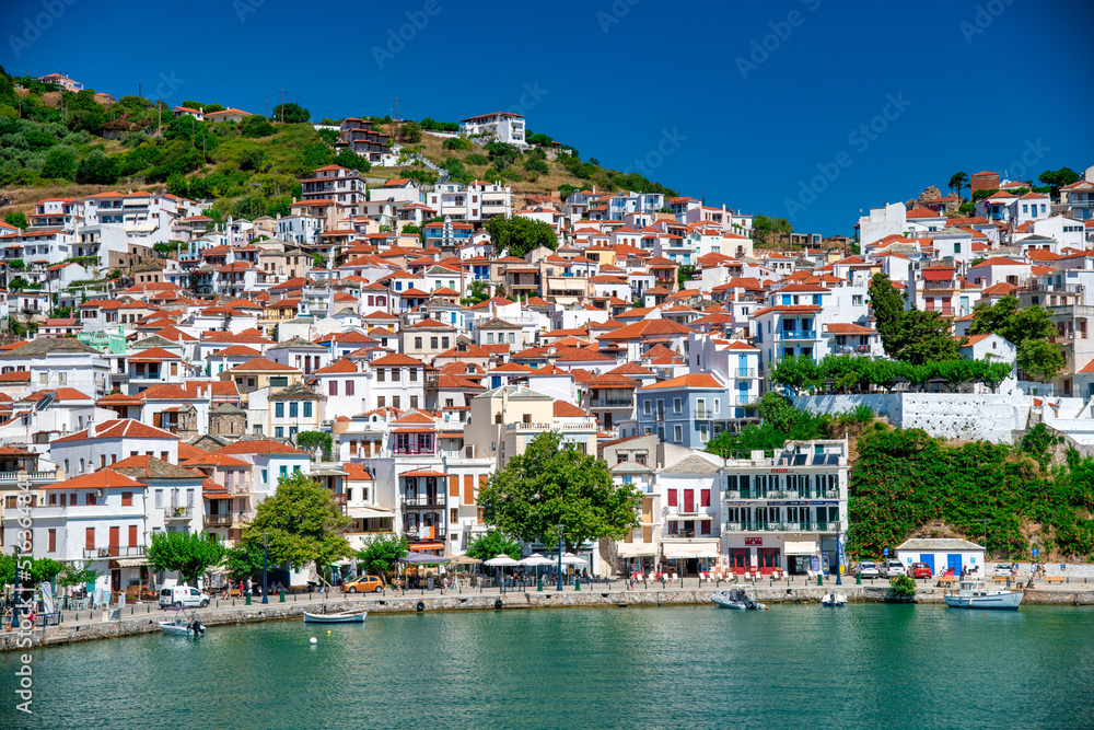 Skopelos, Greece - July 1, 2022: Homes of Skopelos Island along the city port