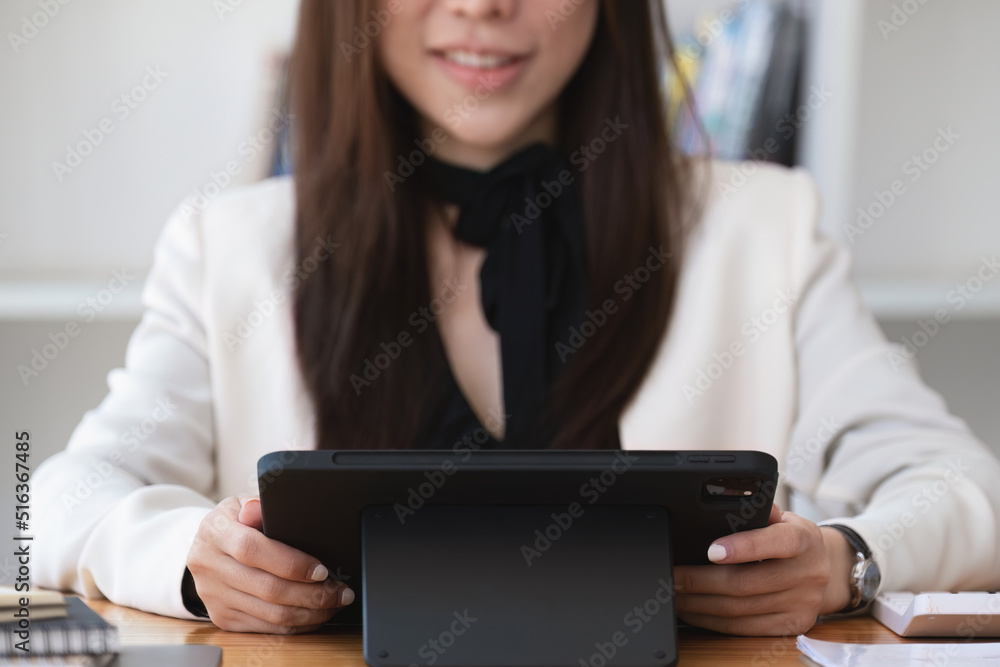 Portrait of a business woman using a tablet computer for data analysis, marketing, accounting Portrait of a business woman using a tablet computer for data analysis, marketing, accounting