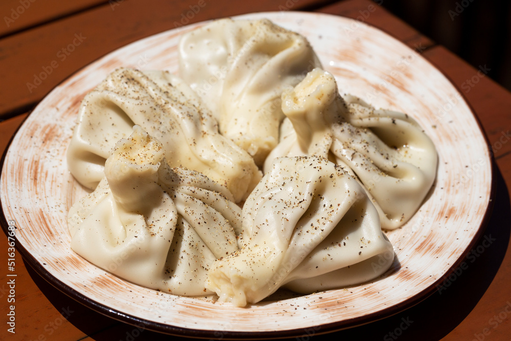 Caucasian cuisine. Close-up Georgian traditional food khinkali dumplings, selective focus. Caucasian cuisine. Close-up Georgian traditional food khinkali dumplings, selective focus.