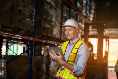 Happy male supervisor with using digital tablet working in warehouse, Logistic industry concept.