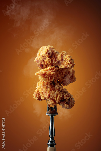 Fried chicken on a fork. © Igor Normann