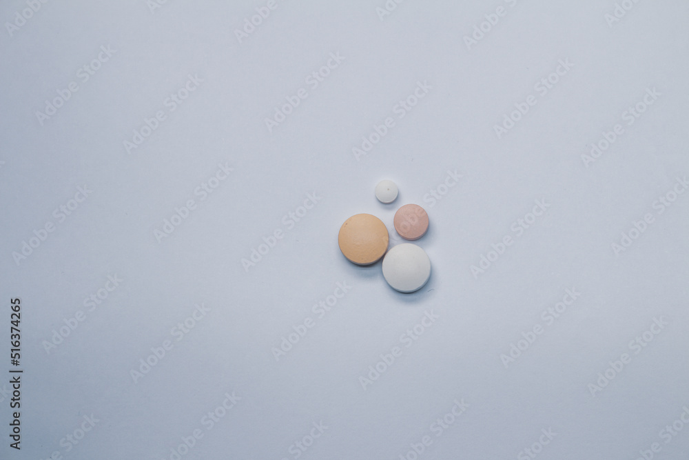 four pills on a white background Free space to write. Concept of self-medication four pills on a white background Free space to write. Concept of self-medication