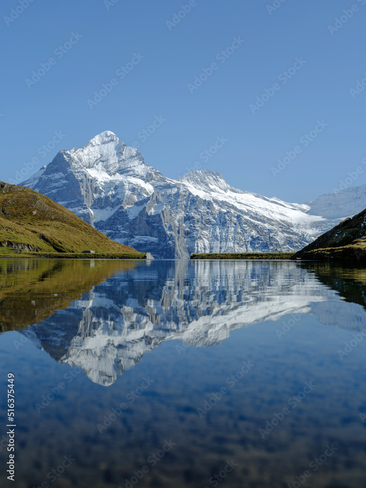 Rocky mountains and reflection on the surface of the lake. Landscape in Grindelwald, Switzerland. the highlands in the summertime