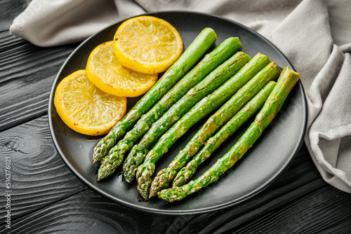 roasted green asparagus on a black wooden rustic background