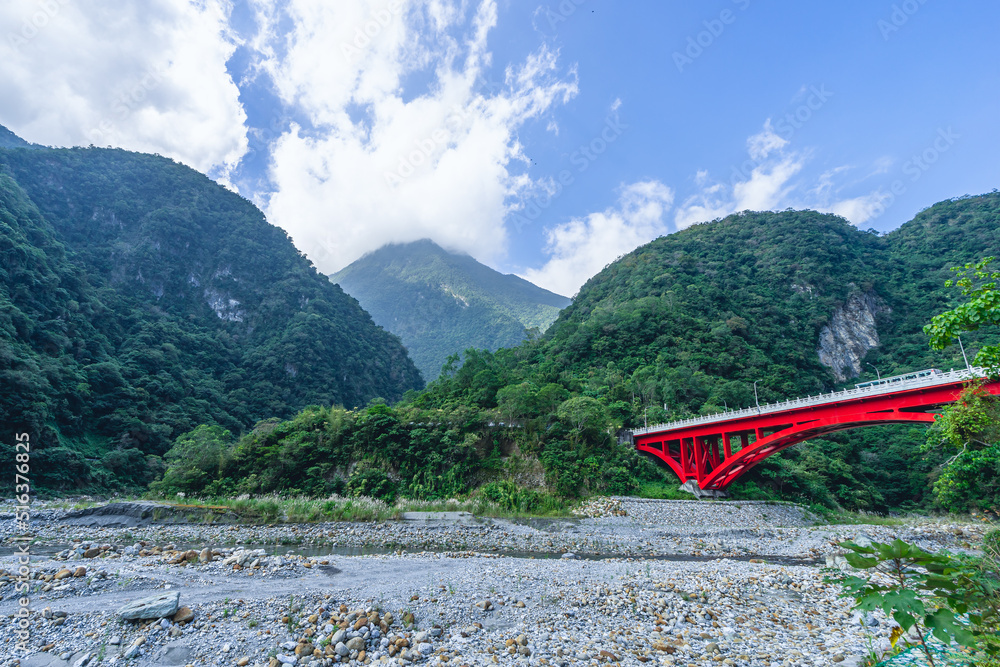 Beautiful natural scenic with the red bridge and mountain in the background.