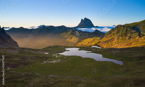 Aerial image of the Anayet lake with the pic of Midi d'Ossau in the background and clouds coming from the north
