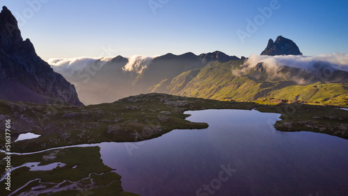 Aerial image of the Anayet lake with the pic of Midi d'Ossau in the background and clouds coming from the north