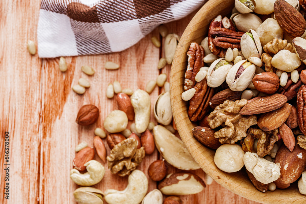set of different nuts on a wooden rustic background set of different nuts on a wooden rustic background