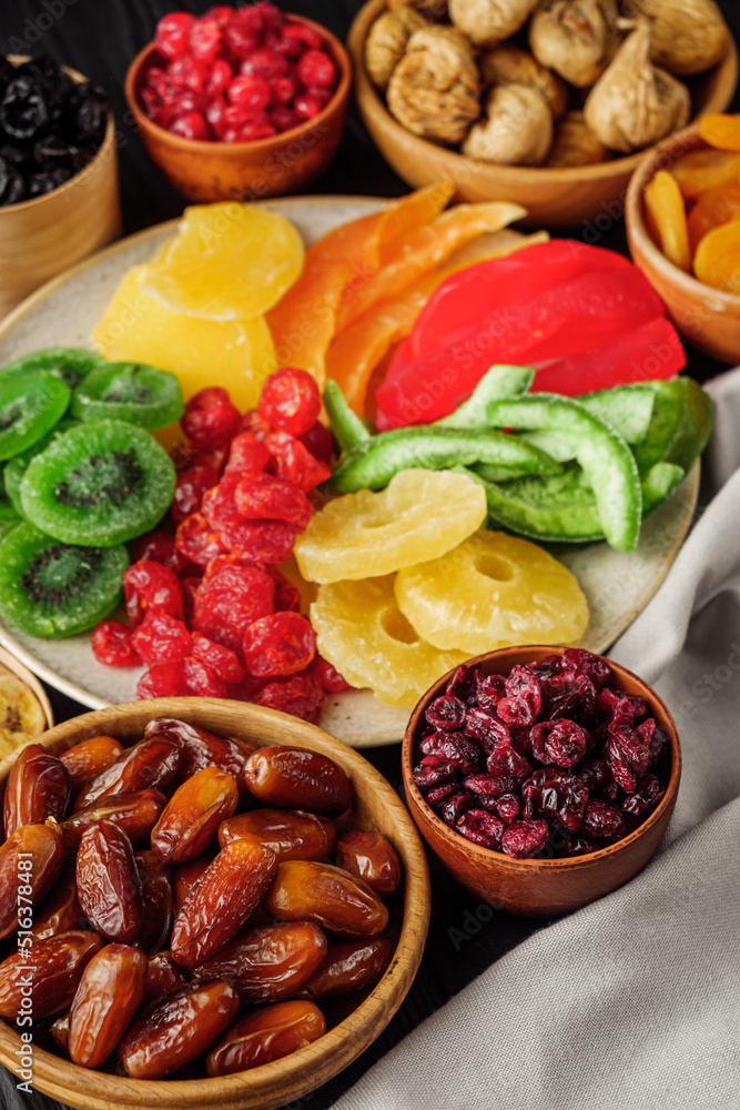 set of various dried fruits on a black wooden rustic background set of various dried fruits on a black wooden rustic background
