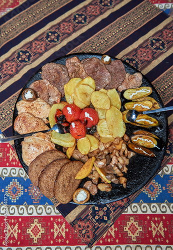 The national Azerbaijani food is a dish called Saj on a large iron pan cooked on a fire all the ingredients together on a fat tail