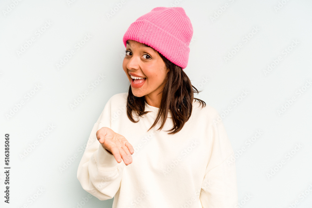 Young hispanic woman isolated on blue background touching temples and having headache. Young hispanic woman isolated on blue background touching temples and having headache.