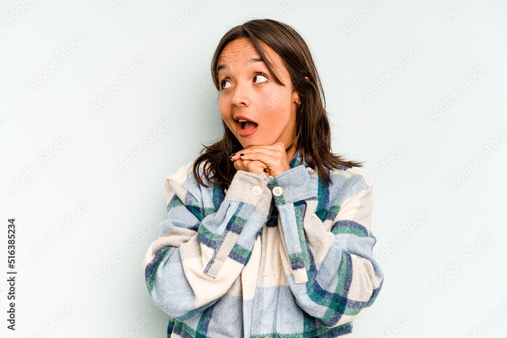 Young hispanic woman isolated on blue background pointing upside with opened mouth. Young hispanic woman isolated on blue background pointing upside with opened mouth.