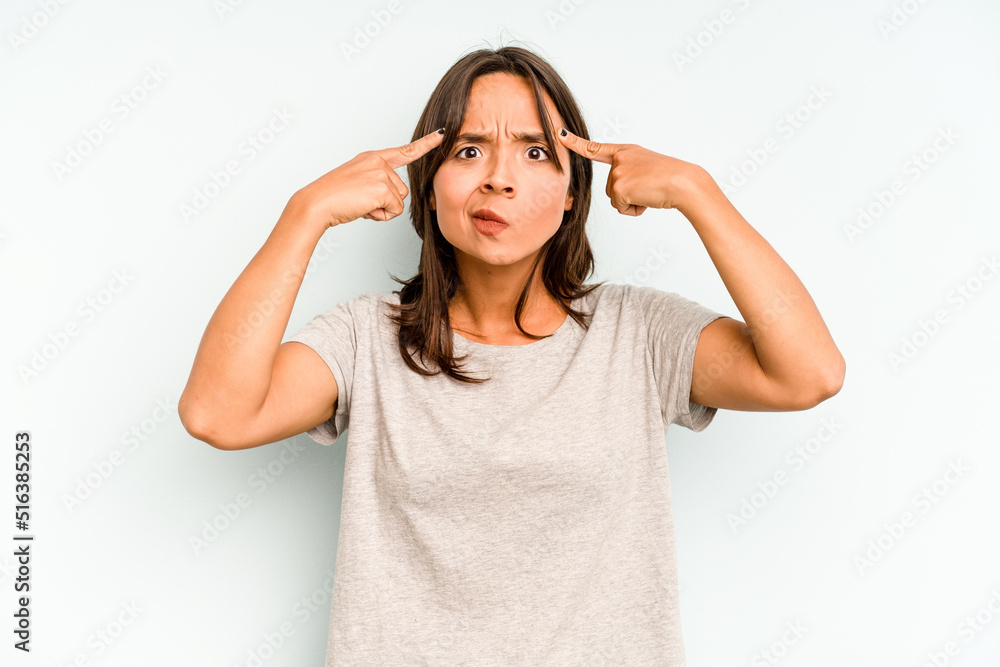 Young hispanic woman isolated on blue background praying, showing devotion, religious person looking for divine inspiration. Young hispanic woman isolated on blue background praying, showing devotion, religious person looking for divine inspiration.