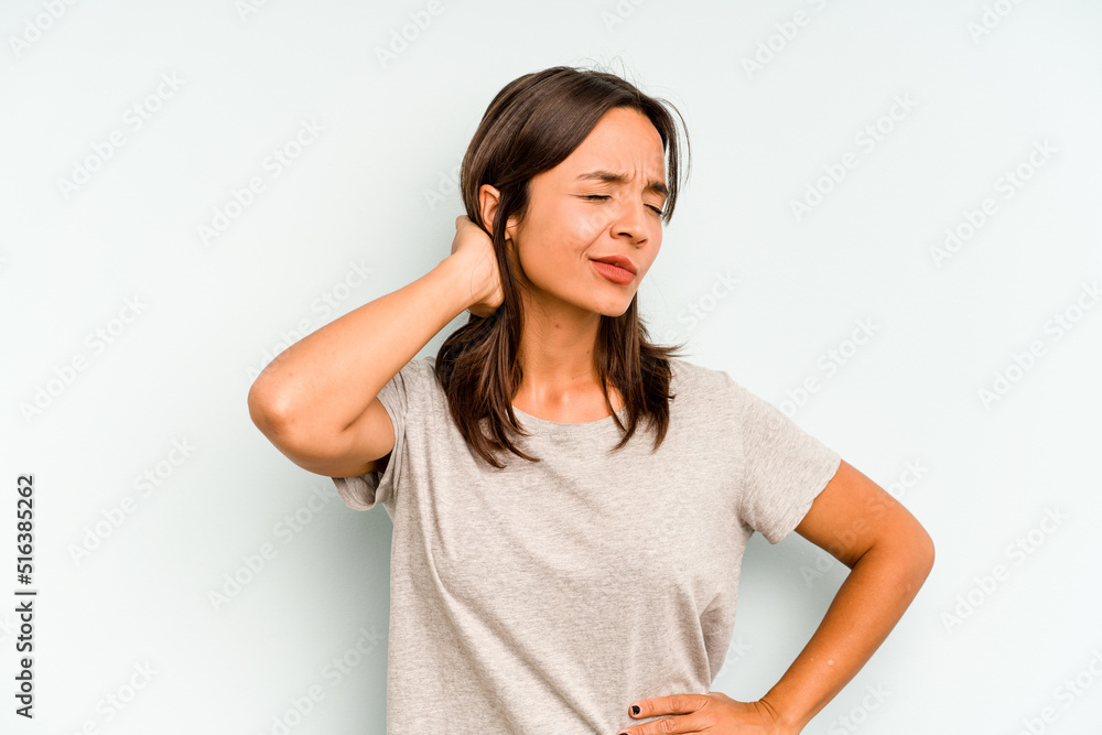 Young hispanic woman isolated on blue background massaging elbow, suffering after a bad movement. Young hispanic woman isolated on blue background massaging elbow, suffering after a bad movement.