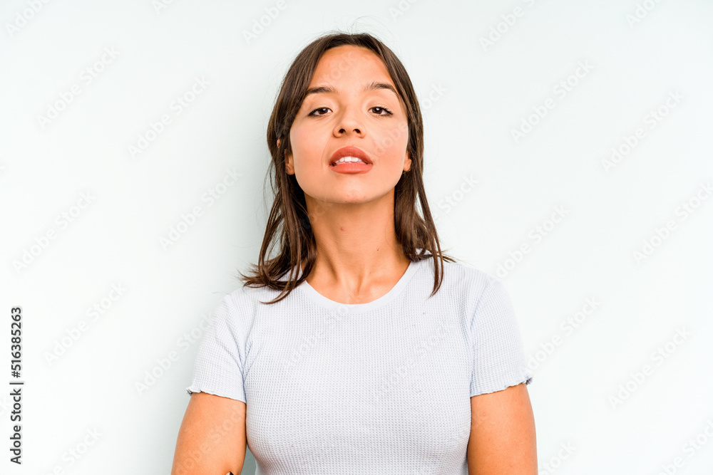 Young hispanic woman isolated on blue background looks aside smiling, cheerful and pleasant. Young hispanic woman isolated on blue background looks aside smiling, cheerful and pleasant.