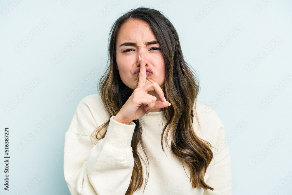 Young caucasian woman isolated on blue background keeping a secret or asking for silence. Young caucasian woman isolated on blue background keeping a secret or asking for silence.