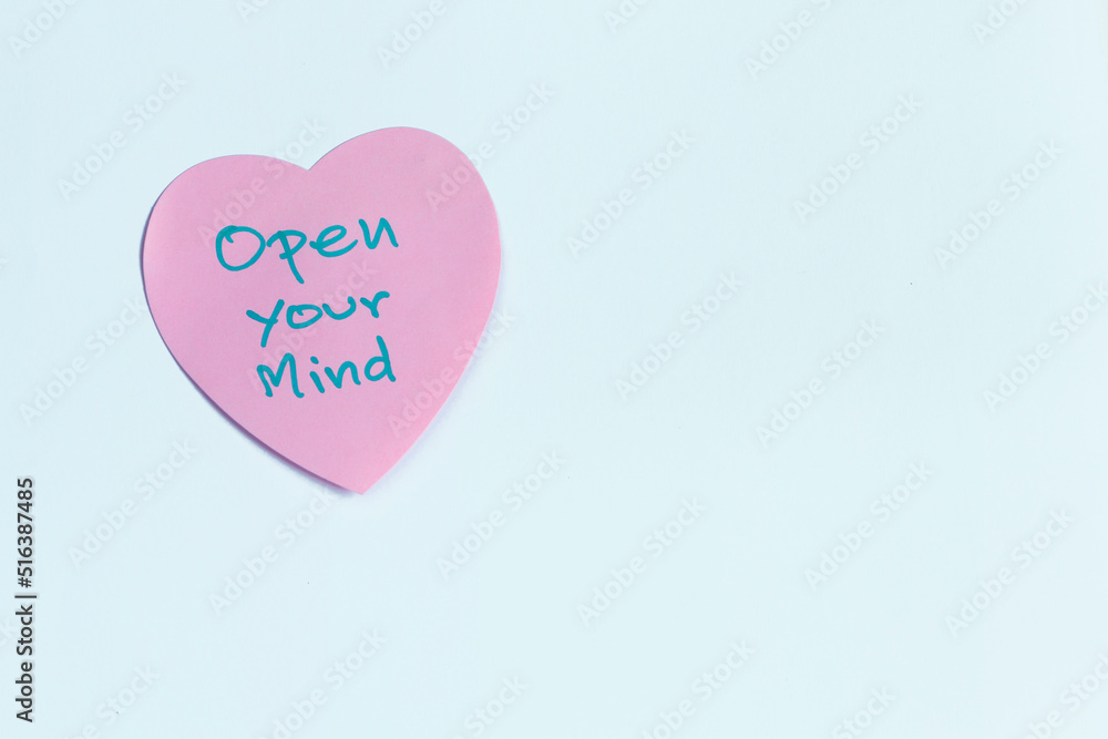 Open Your Mind message on pink heart shape paper, motivation and inspiration message 