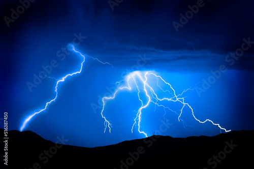 Lightning Bolts on Mountain with Radio Tower Blue Sky Silhouette