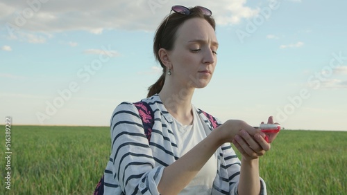 4K. A young woman navigates the field by compass