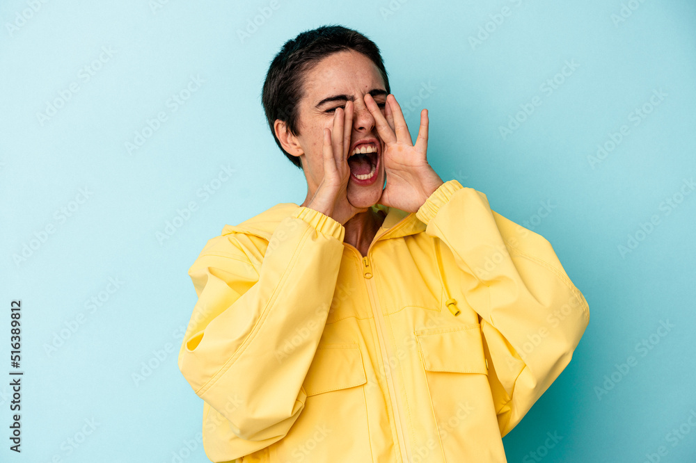 Young caucasian woman isolated on blue background shouting excited to front. Young caucasian woman isolated on blue background shouting excited to front.