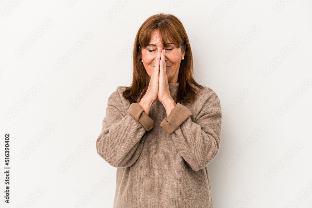 Middle age caucasian woman isolated on white background holding hands in pray near mouth, feels confident. Middle age caucasian woman isolated on white background holding hands in pray near mouth, feels confident.