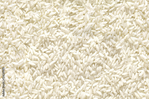 Medium and round grain white jasmine rice texture for background. Organic natural food background with copy space for text, top view. Close up rice grains flat lay. Healthy food macro concept.